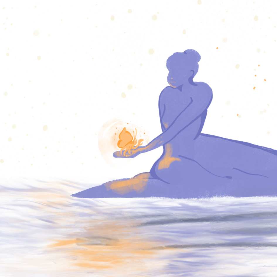 Indigo sitting on a beach holding a glowing crab